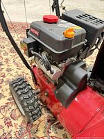 Engine and wheel close-up showing Craftsman engine cover and overall condition