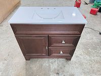 Front view showing vanity, sink top, cabinet door, two drawers