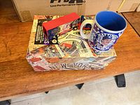 Mug, diecast truck, and decorative box on table