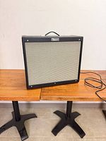 Front view showing grille, logo, handle, overall cabinet