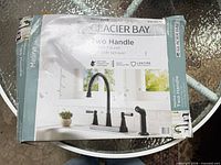 Sealed box showing Glacier Bay Melina two-handle kitchen faucet matte black