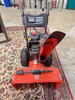 Front view showing auger housing, chute, control panel