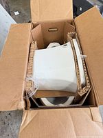 Toilet components inside original cardboard packaging