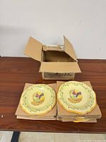 Open Lifetime Brands box with stacked yellow fruit salad plates on cardboard