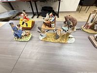 Group view of ducks in flight, shoemaker and boy, craftsman with dog, soldier on roof