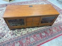 Top view showing overall TV stand, cable pass-through cutout, wood grain