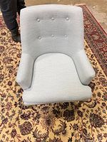 Front view showing upholstery color and button-tufted back