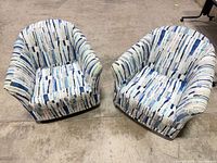 Pair of fabric upholstered swivel chairs front view