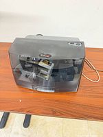 Front view of Primera Bravo 4100 disc publisher showing tinted lid and control buttons