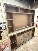Full view of assembled entertainment center showing upper hutch and lower cabinet
