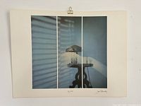 Full view of unframed lithograph showing image and margins with clip