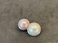 Front view showing two round cabochon stones in white gold setting