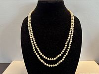 Necklace displayed on bust showing double strand arrangement and pearl size