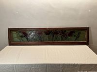 Full view of rectangular stained glass panel on table