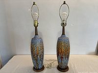 Pair of ceramic and teak table lamps full view