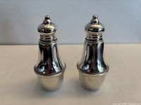 Front view of both sterling shakers