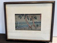 Front view of framed woodblock print under glass