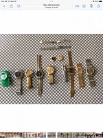 Overview of ten wristwatches, two spare bands and loose parts on checkered surface