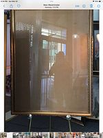 Full view of gold picture frame on easel