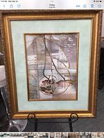 Full view of framed print on stand