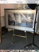 Full view of framed orca print on easel