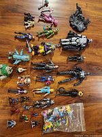 Group view of all action figures, ship part and bag of Pokémon minis