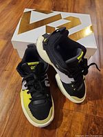 Pair of Jordan One Take 5 shoes displayed beside box