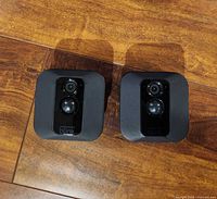 Front view of both Blink Outdoor cameras