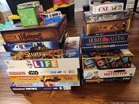 Two stacks of boxed board games showing titles listed