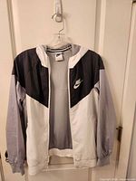Front view of Nike white/grey/black hooded windbreaker