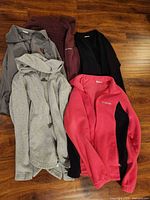 All five jackets and pullover laid out