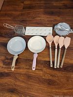 Group of pans, utensils, baskets, mold, press