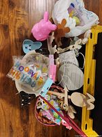 group of Easter items scattered, showing pink bunny figure, eggs, lantern, clings, craft pieces