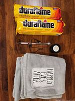 Group shot with two Duraflame logs, pink USB lighter, Horchata candle, grey throw