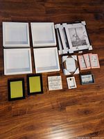 Group layout of all frames and signs on wood floor