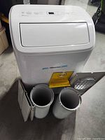 Front view of Hisense portable air conditioner with accessories displayed