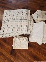 Folded patterned comforter with accompanying sheets and pillowcases