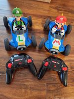 Front view of both Mario and Luigi RC cars with controllers