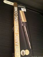 Front of retail box showing ceramic pressing comb and product image