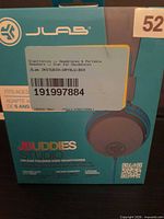 Front of retail box showing JLab JBuddies Studio headphones model and branding