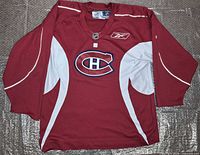 Front view of Montreal Canadiens Reebok practice jersey laid flat