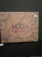 Front of cardboard envelope showing Disney’s Mulan logo