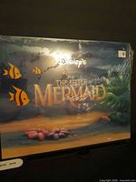 Front of sealed Little Mermaid lithograph portfolio