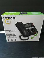 Front of VTech retail box showing black corded speakerphone