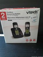 Front of retail box showing VTech branding, two cordless handsets and answering base