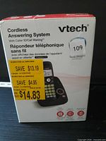 Front of boxed VTech cordless answering system showing product image and pricing stickers