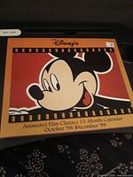 Front cover showing Mickey artwork and title "Animated Film Classics 15-Month Calendar October '98–December '99"