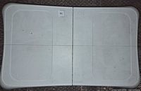 Top view of Wii Balance Board showing standing surfaces and wear