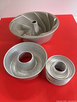 All three pan types grouped on red surface