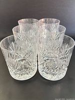 Front view of six cut crystal glasses